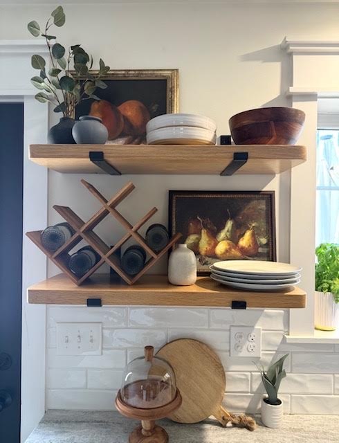 Kitchen open shelving with still life paintings and wooden bowls